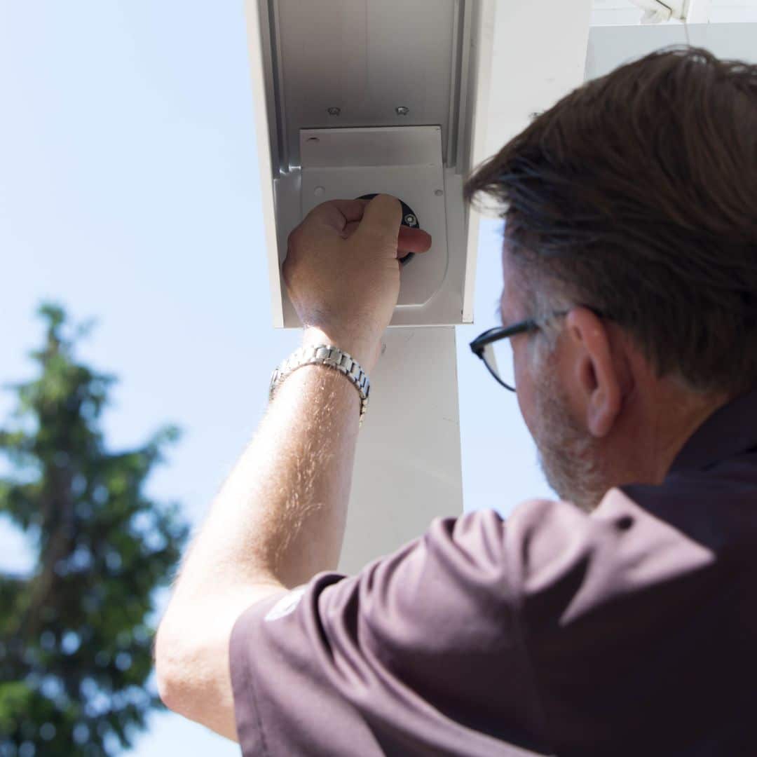 A person working on a patio cover installation.