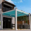 A render of an Outlook Aluminum Patio Cover shading an outdoor dining table, low angle view